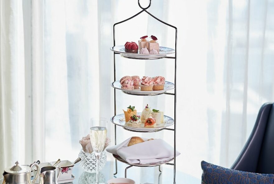 Elegant afternoon tea with a four-tiered cake stand.