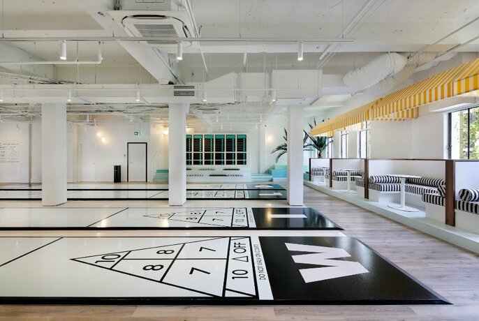 Large white room with columns and numbers in a triangle on the floor.