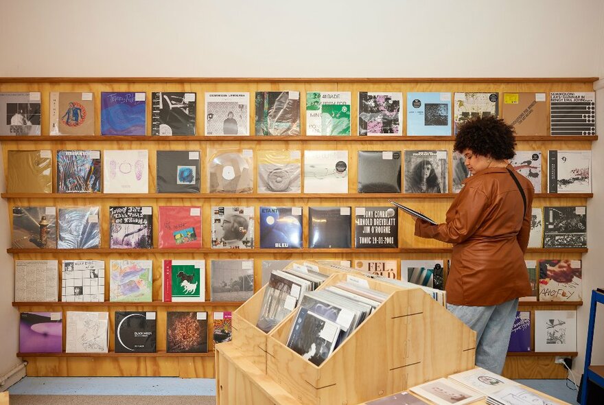 A woman is browsing records in a record store
