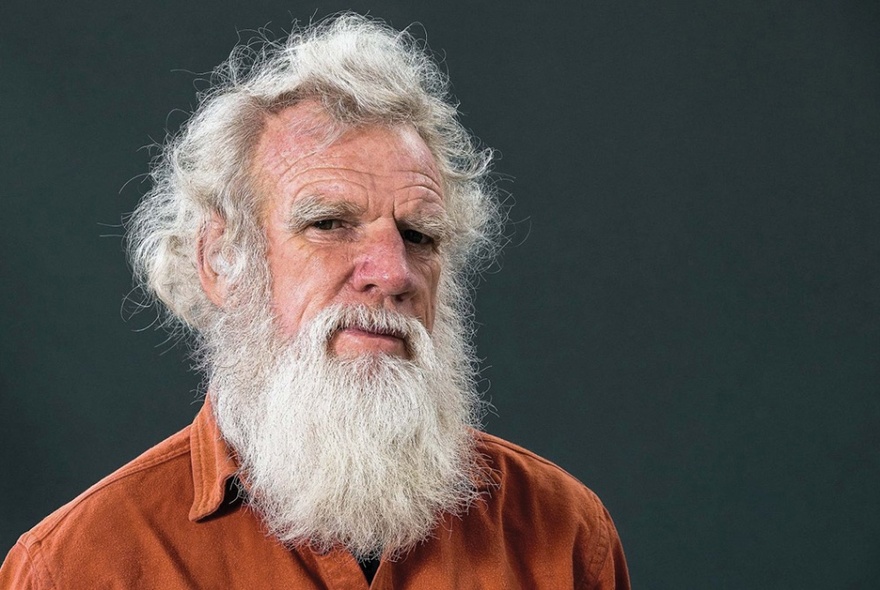 Writer Bruce Pascoe with a long white beard and pensive look.