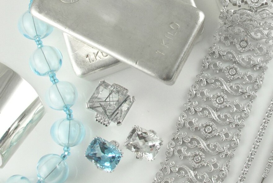 Selection of jewellery including beads, rings and silver bars.