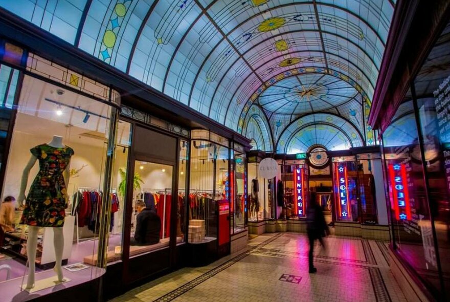 A woman walking through a shopping arcade