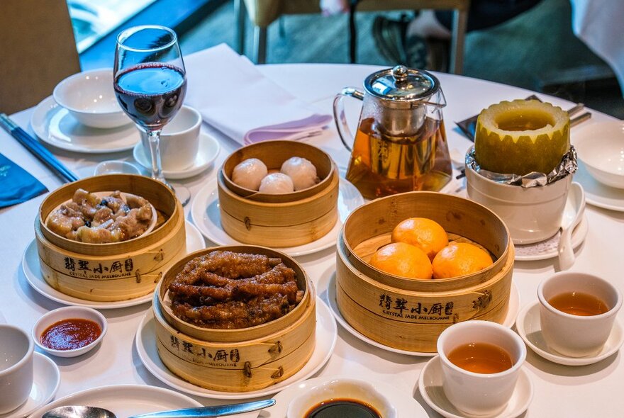A table set with baskets of yum cha dishes and tea.