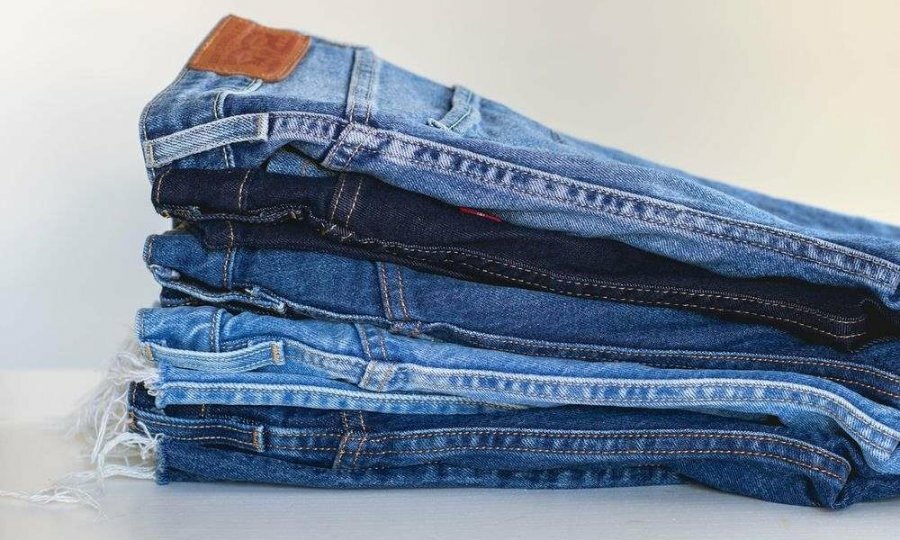 A stack of jeans on a white background