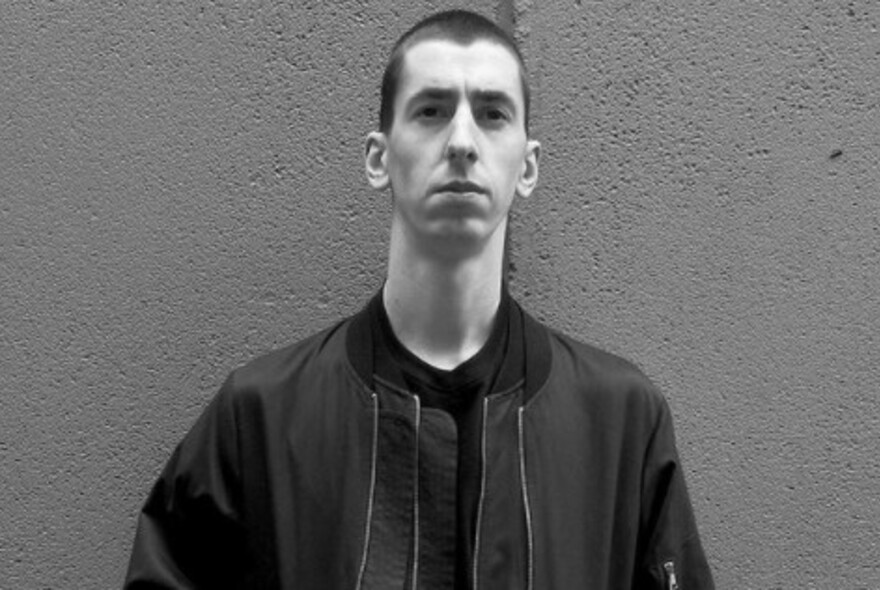 Long-necked male model with crewcut wearing a Harrington jacket.