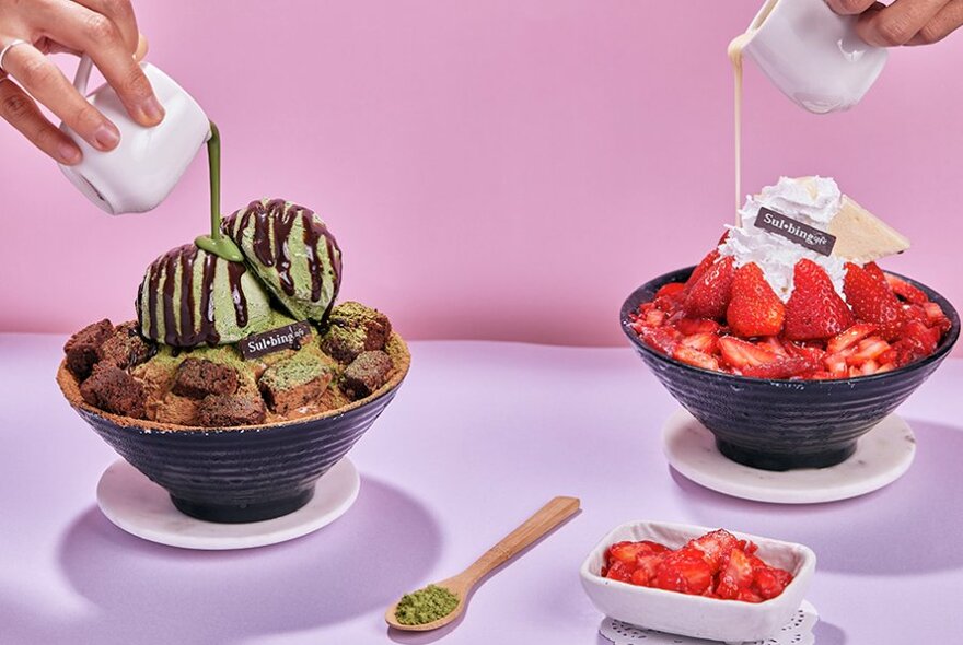 Two bingsu bowls with chocolate being drizzled on top. One is choc mint, the other is strawberry. 