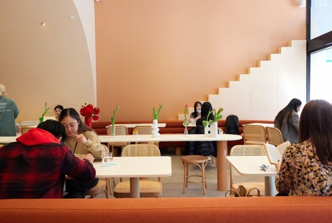 People seated in a modern-looking cafe.