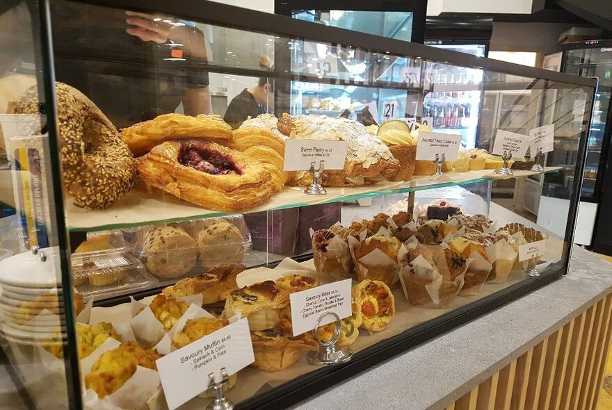Glass cabinet full of pastries.