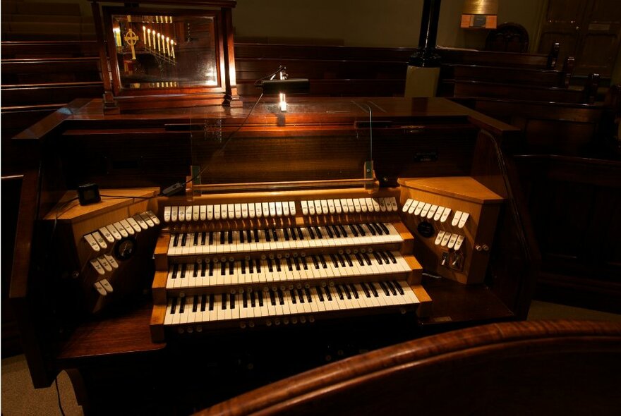 A church organ with a soft glowing light. 