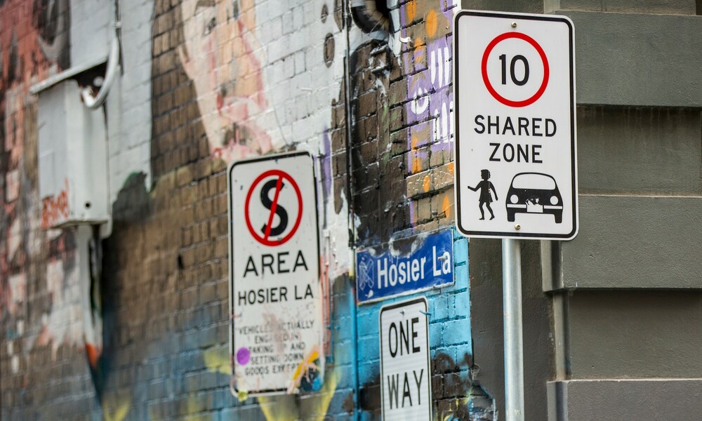 A Shared Zone sign and No Stopping sign next to Hosier Lane. 