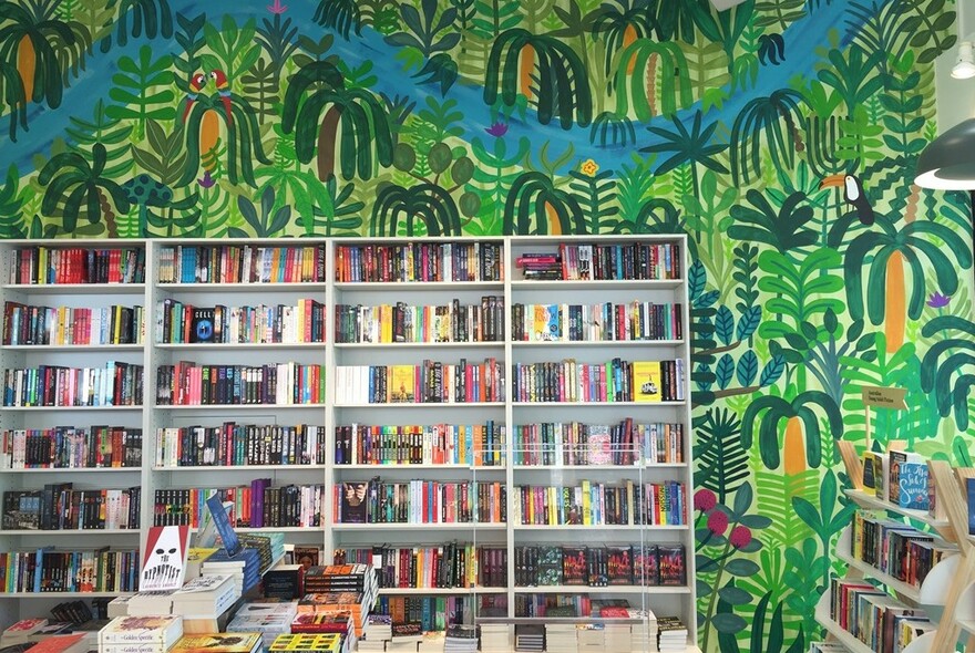 Kids books and verdant jungle wall mural.