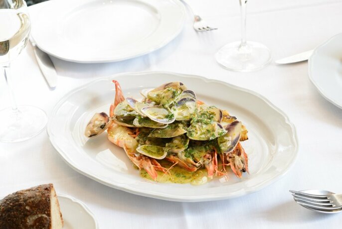 A fine dining table set with a seafood fish.