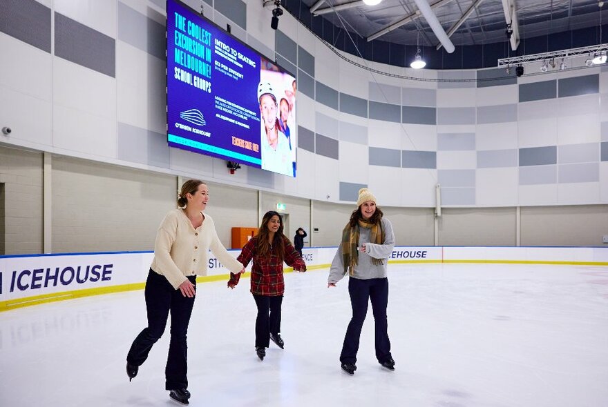 Three girls ice skating