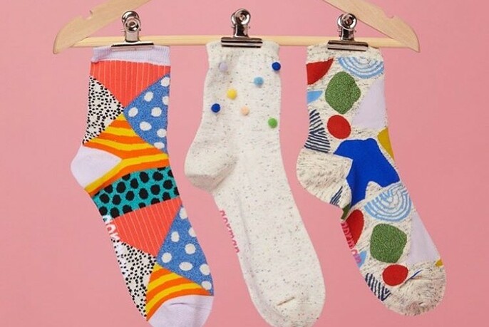 Brightly-coloured socks on a hanger.