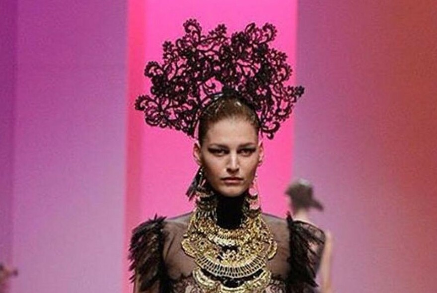 Woman wearing ornate black headdress.