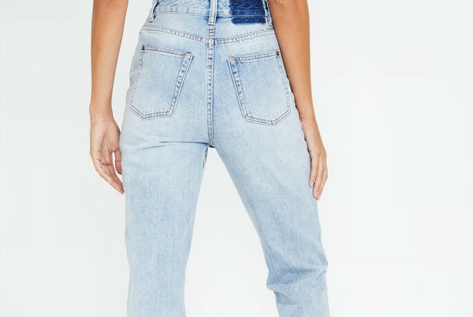 Waist down, back view of light blue jeans.