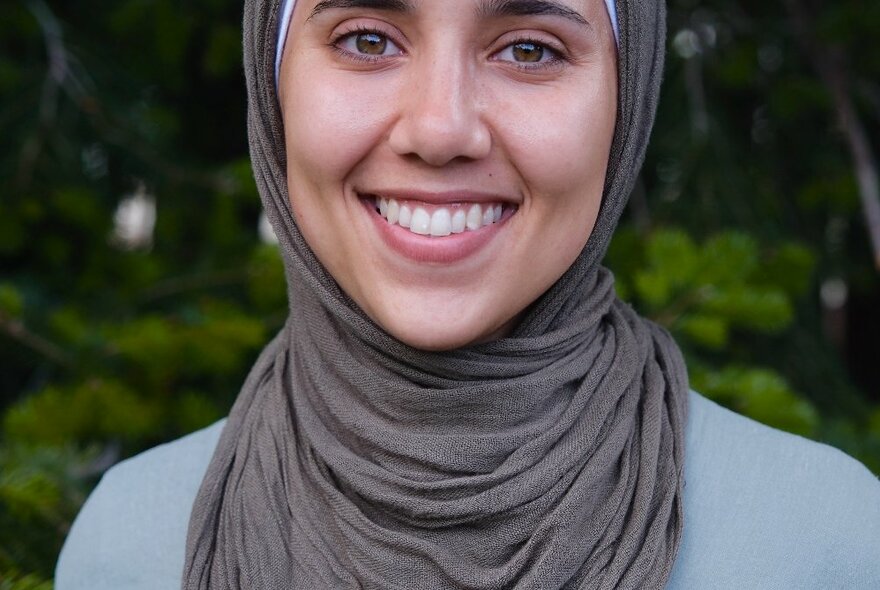 Author Jumaana Abdu smiling warmly wearing a hijab.