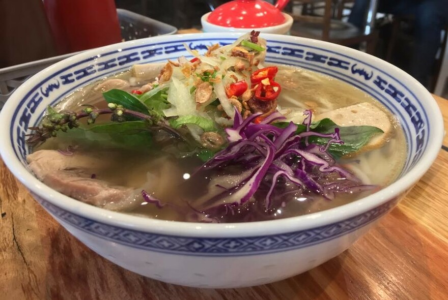 A blue and white bowl of pho.