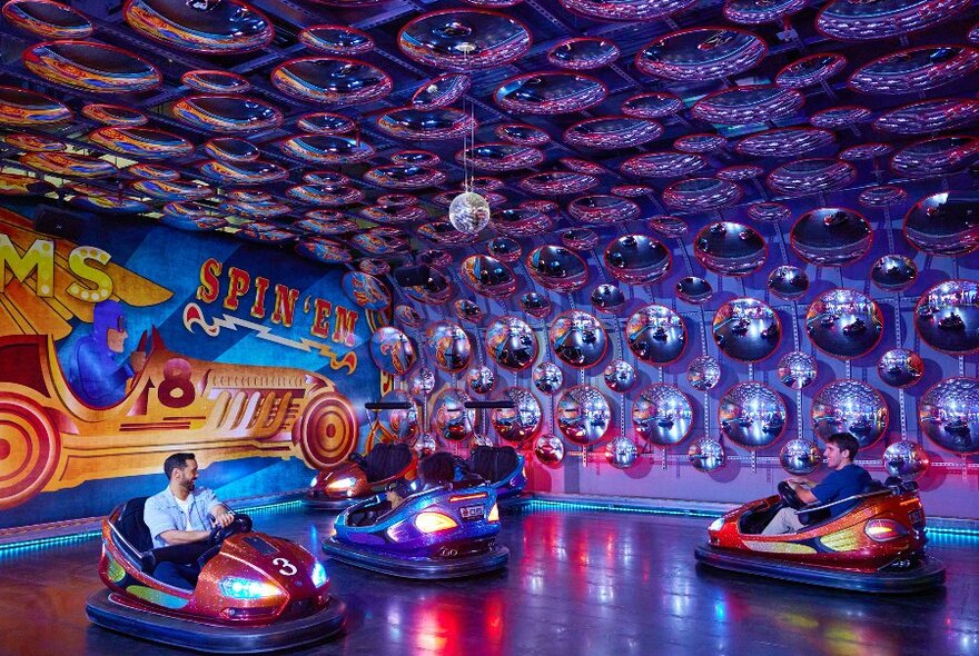 Three people driving bumper cars