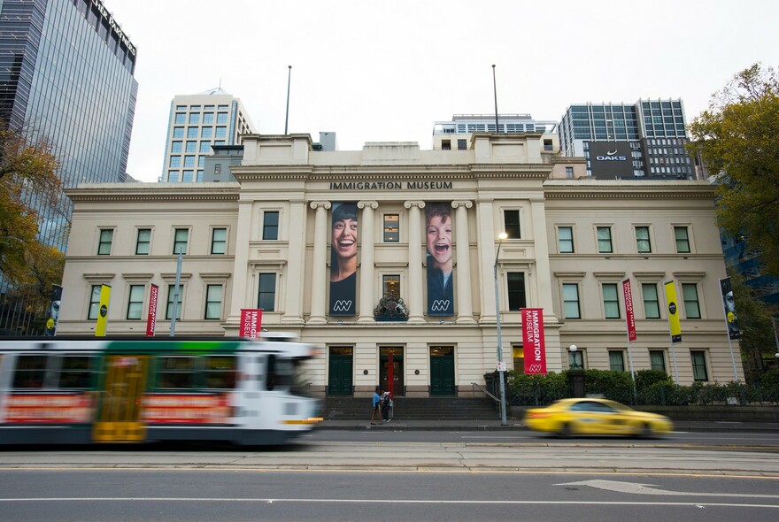 Three-storey historic building of the Immigration Museum on busy Flinders Street.