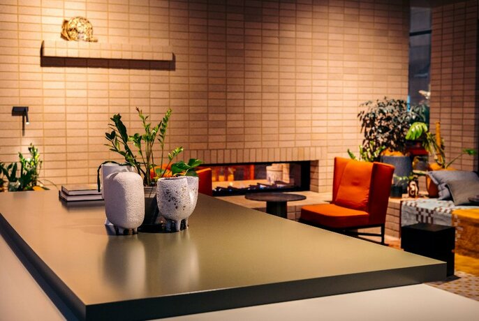 Cosy cafe area in hotel lobby with seating and tables.