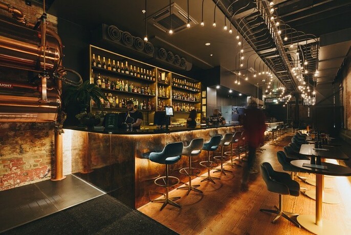 Modern-looking bar with a row of bar stools.