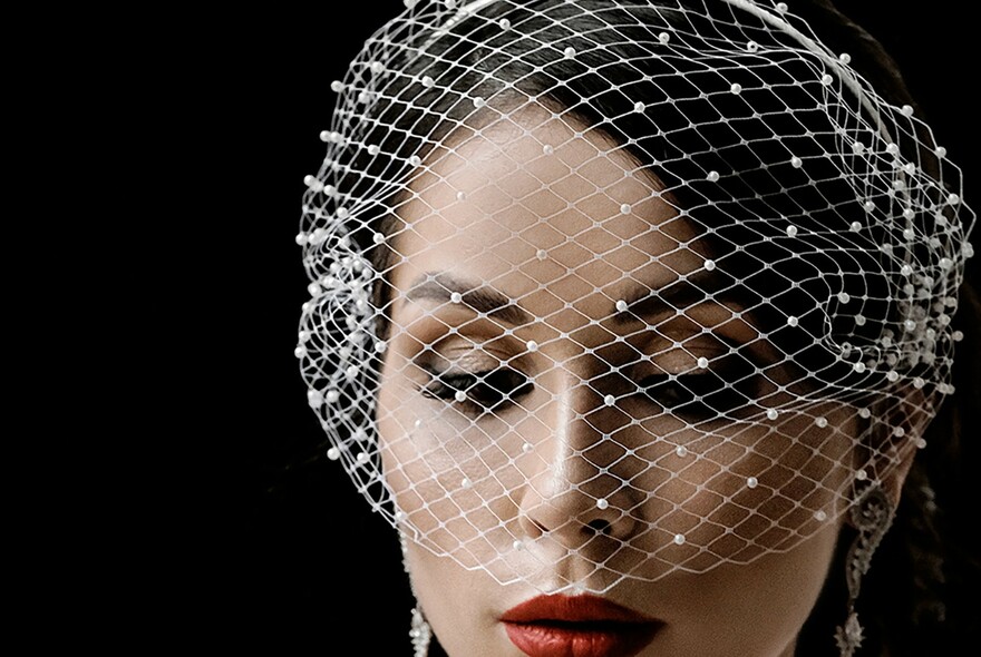 Woman wearing white mesh veil.