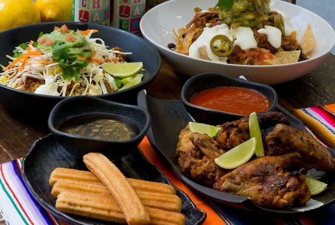 A feast of Mexican food on a colourful tablecloth