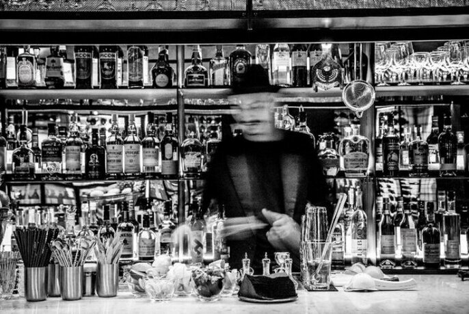 A bartender making a cocktail at Arlechin.