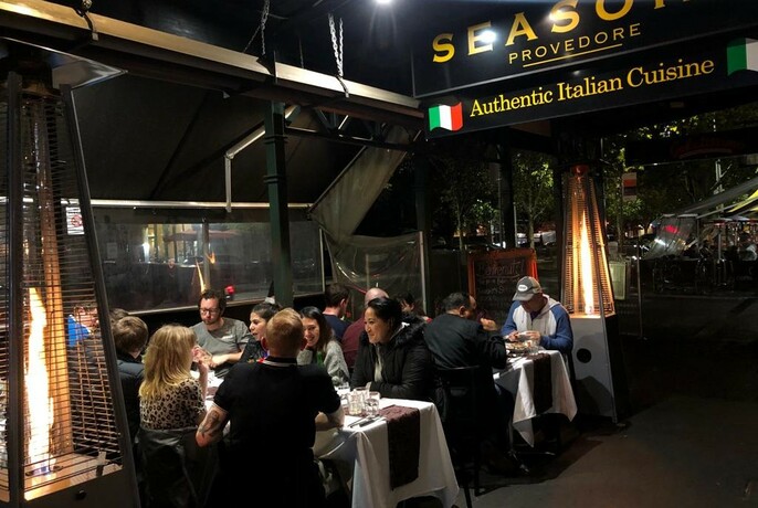 People seated at tables in Seasons Provedore Italian restaurant.