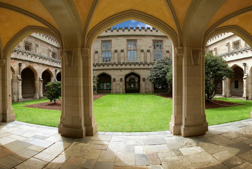 Cloistered walkway and grassy courtyard in historic University of Melbourne.