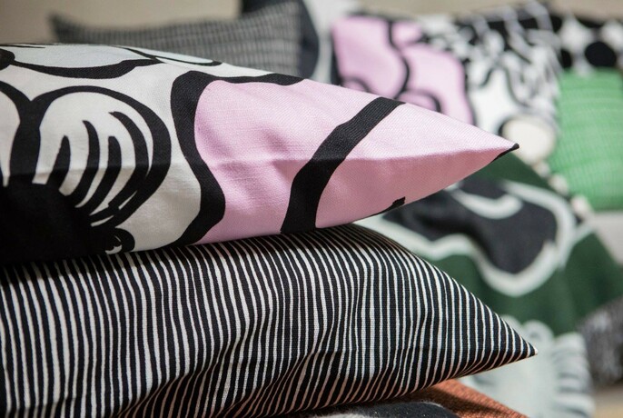 Two cushions with black, white and pink designs.
