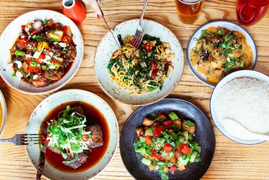 A table set with Asian fusion dishes.