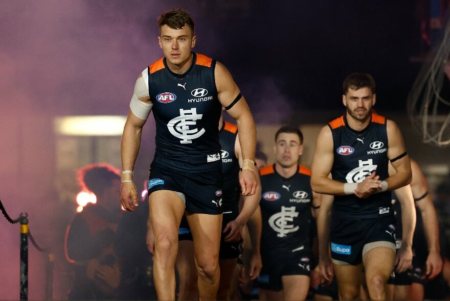 Carlton players coming out of the rooms during a football match. 