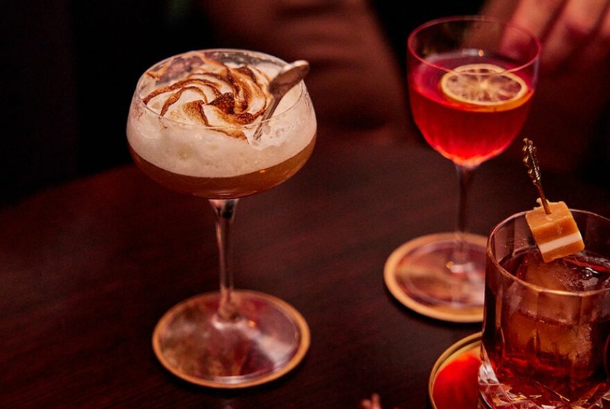 Three cocktails garnished with toasted meringue, lemon and a jersey caramel. 