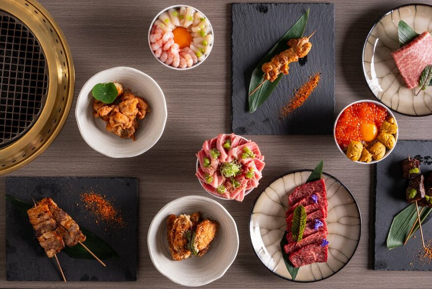 An array of Japanese barbecue dishes beautifully presented on Japanese-style serving plates.