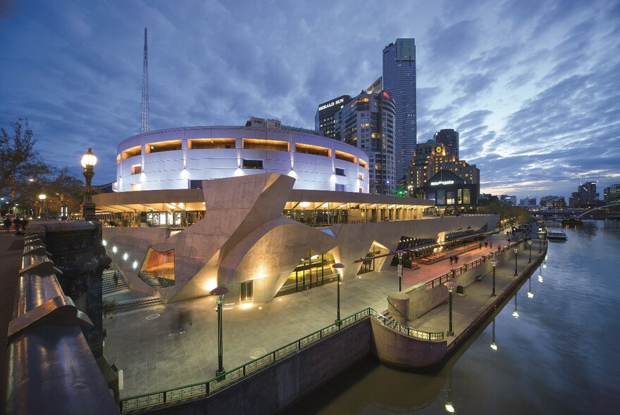 Hamer Hall and the Arts Centre at night,beside the Yarra River.