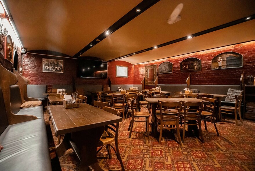 Mitre Tavern interior with tables, chairs and bench seating.