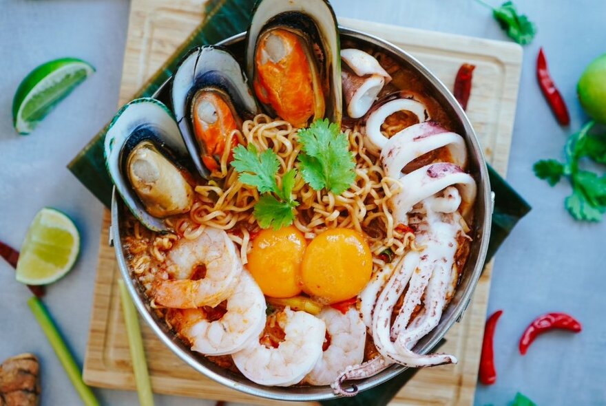 Seafood and egg yolks on a bed of noodles.