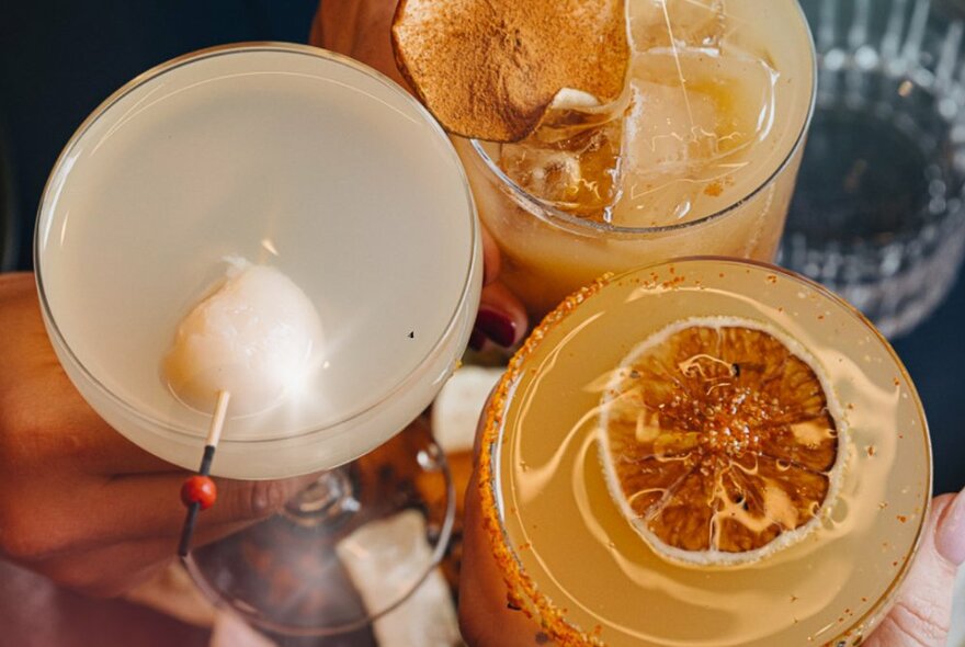 Looking down at the top of three cocktails.