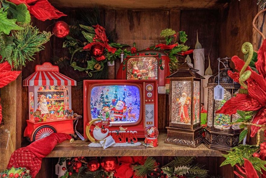 Santa on toy TV, lanterns and other Christmas decorations.