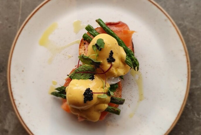 Eggs Benedict, with smoked salmon and asparagus, viewed from above.