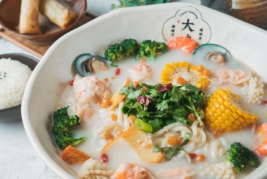 Sichuan seafood hotpot soup with corn.