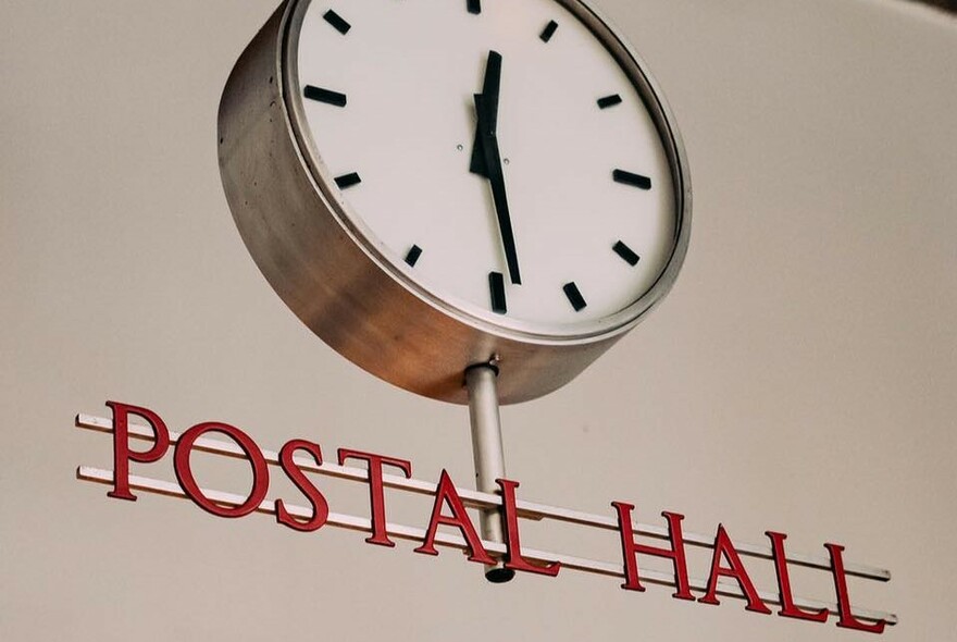 Postal Hall vintage metal sign and old post office clock.