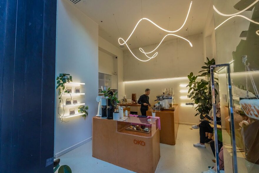A stylish cafe with a squiggle neon light. 