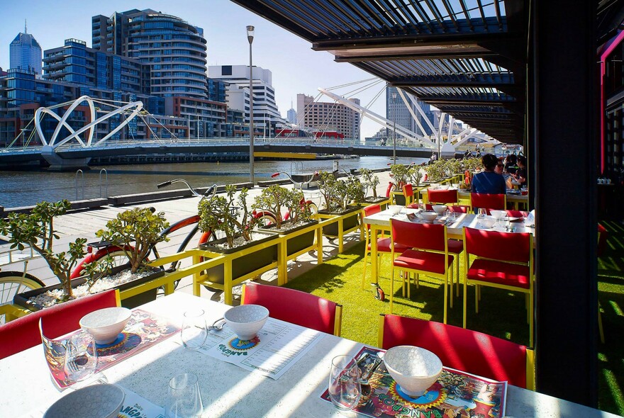 Colourful outdoor table settings at BangPop overlooking the Yarra River and the city.