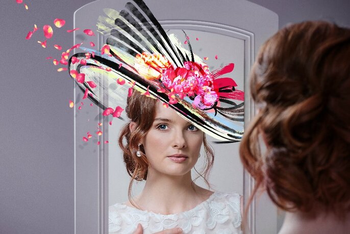 Woman looking in a mirror, the 'mirror' version of her wearing a fancy racing style large hat that has been superimposed on her head.