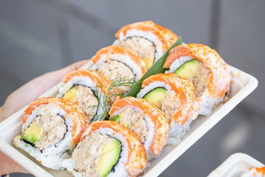 A tray of sliced sushi rolls.