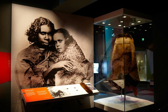 Historic photo of Aboriginal people and possum cloak at Melbourne Museum's Bunjilaka Aboriginal Cultural Centre.