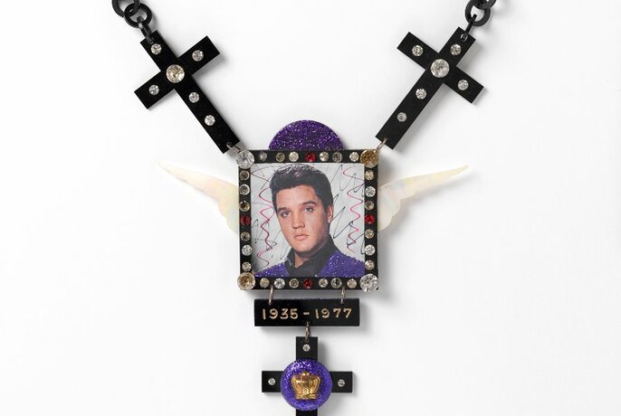 Pendant depicting the face of Elvis Presley, adorned with small gems.